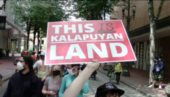 [Protest sign: This is Kalapuyan Land]